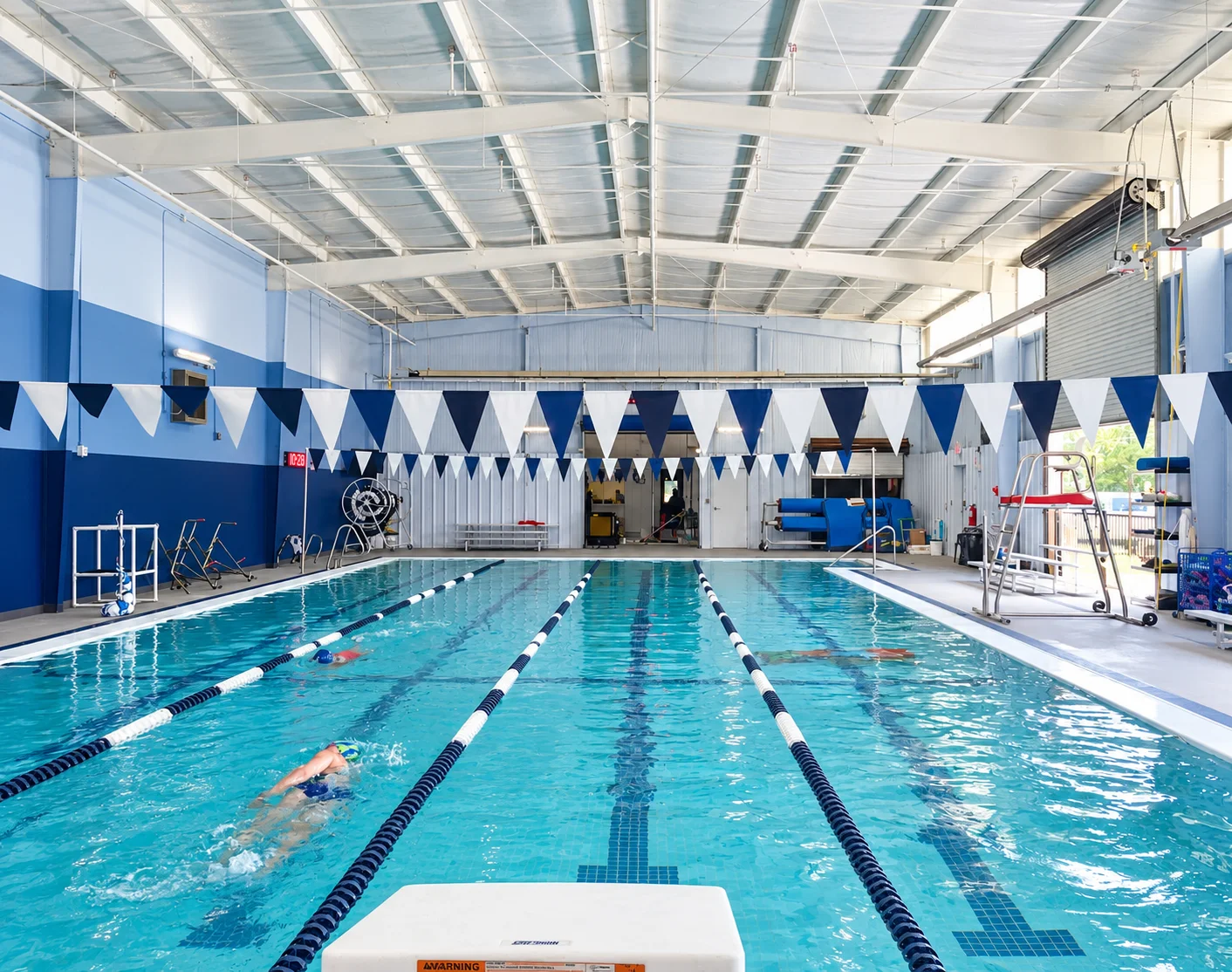 Swimmers doing laps in the four-lane 25-yard indoor heated competition pool at The Pod Aquatics in Oak Ridge North, Texas